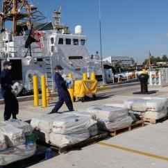 Crewmembers off-load 2500 lbs of cocaine from Coast Guard Cutter Sitkinak. Photo by Petty Officer 1st Class Crystalynn Kneen